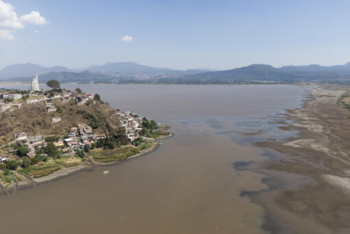 Janitzio Island stands in Lake Patzcuaro, which has low water levels during a drought in Mexico, Thursday, April 18, 2024. Farmers are starting to pasture livestock and plant crops on the lake bed.