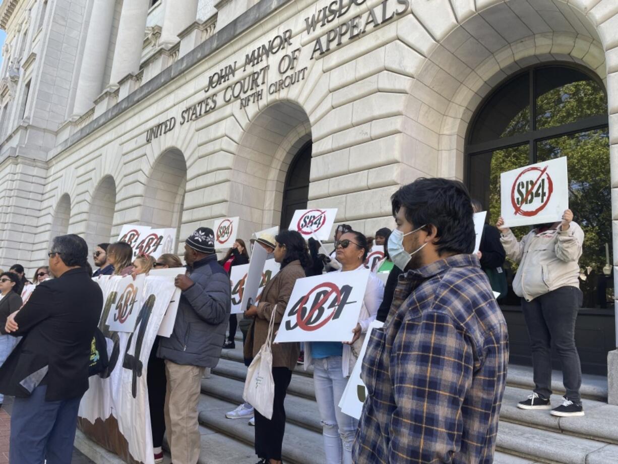 Demonstrators gather outside federal court buildings in New Orleans on Wednesday, April 3, 2024, to protest a Texas law known as SB4.  Texas officials appeared before a three-judge federal appeals panel to defend a state law that would allow police to arrest migrants for illegally entering the United States, a week after the same three judges put the law on hold.
