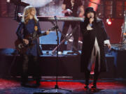 FILE - Nancy Wilson, left, and Ann Wilson, right, of the band Heart perform as Heart is inducted into the Rock and Roll Hall of Fame during the Rock and Roll Hall of Fame Induction Ceremony at the Nokia Theatre on Thursday, April 18, 2013 in Los Angeles.
