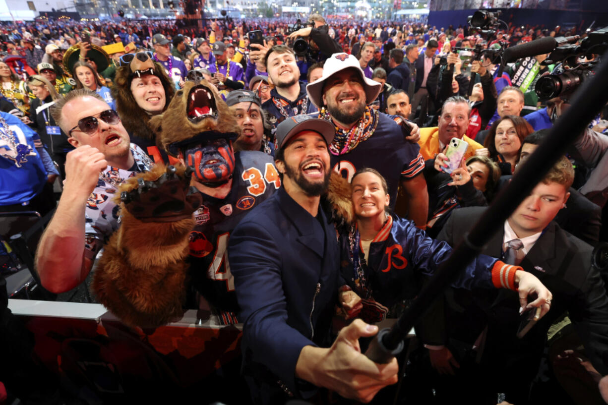 USC quarterback Caleb Williams celebrates among Chicago Bears fans after being chosen No.