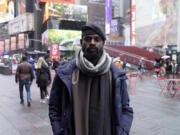 In this screen grab taken from video, Tunde Onakoya, 29- years old, a Nigerian chess champion and child education advocate, poses on the street in Times Square, New York, Thursday, April, 18, 2024. A Nigerian chess player and child education advocate is attempting to play chess nonstop for 58 hours in New York City&rsquo;s Times Square to break the global record for the longest chess marathon and raise $1m for the education of children across Africa.
