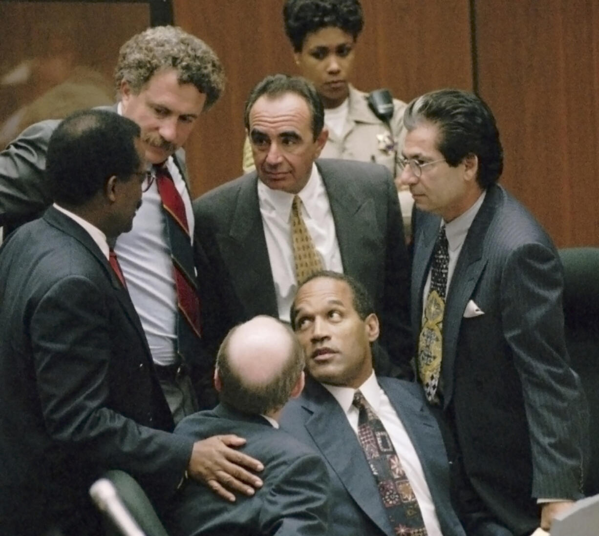 FILE- Defendant O.J. Simpson is surrounded by his defense attorneys, from left, Johnnie L. Cochran Jr., Peter Neufeld, Robert Shapiro, Robert Kardashian, and Robert Blasier, seated at left, at the close of defense arguments in his murder trial, Thursday, Sept. 28, 1995, in Los Angeles. Simpson, the decorated football superstar and Hollywood actor who was acquitted of charges he killed his former wife and her friend but later found liable in a separate civil trial, has died. He was 76.