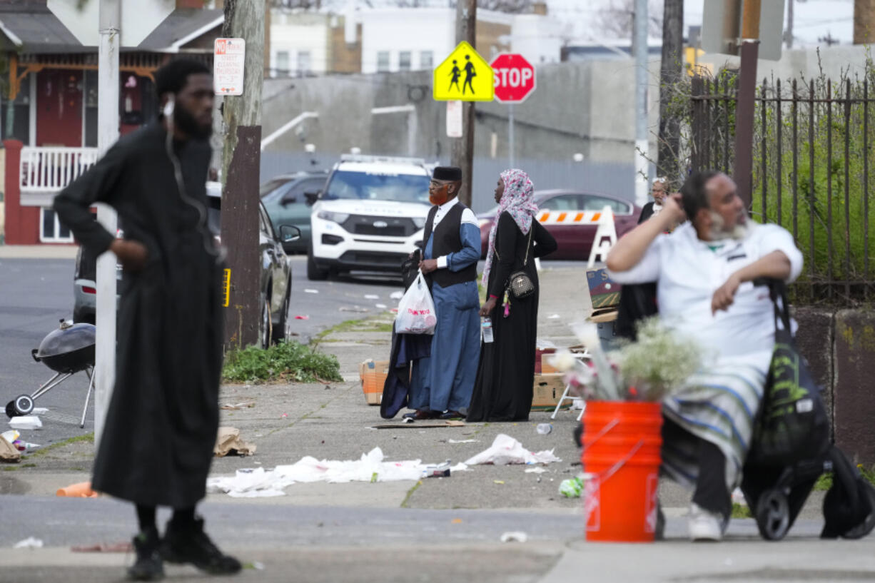 People gather in the aftermath of a shooting at an Eid al-Fitr event in Philadelphia, Wednesday, April 10, 2024.