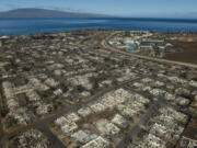 FILE - The aftermath of a wildfire is visible in Lahaina, Hawaii, Aug. 17, 2023. The nonprofit Entertainment Industry Foundation says the People&rsquo;s Fund of Maui, which was started by Oprah Winfrey and Dwayne Johnson to benefit survivors of the wildfires last summer, has given away almost $60 million over six months to 8,100 adults. (AP Photo/Jae C.
