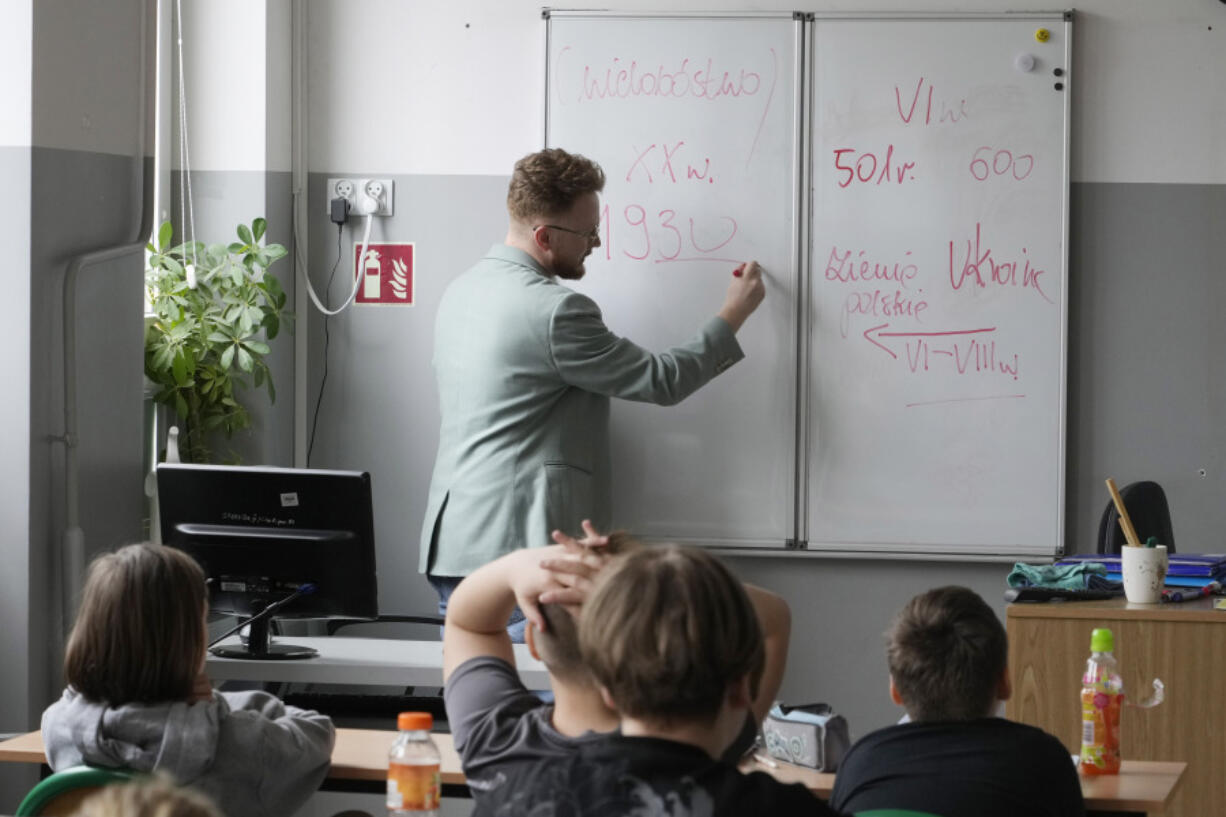 Arkadiusz Korporowicz teaches history to fifth-grade children April 3 at Primary School number 223 in Warsaw, Poland. Poland&rsquo;s government has ordered strict limits on the amount of homework that teachers can impose on the lower grades, starting in April.