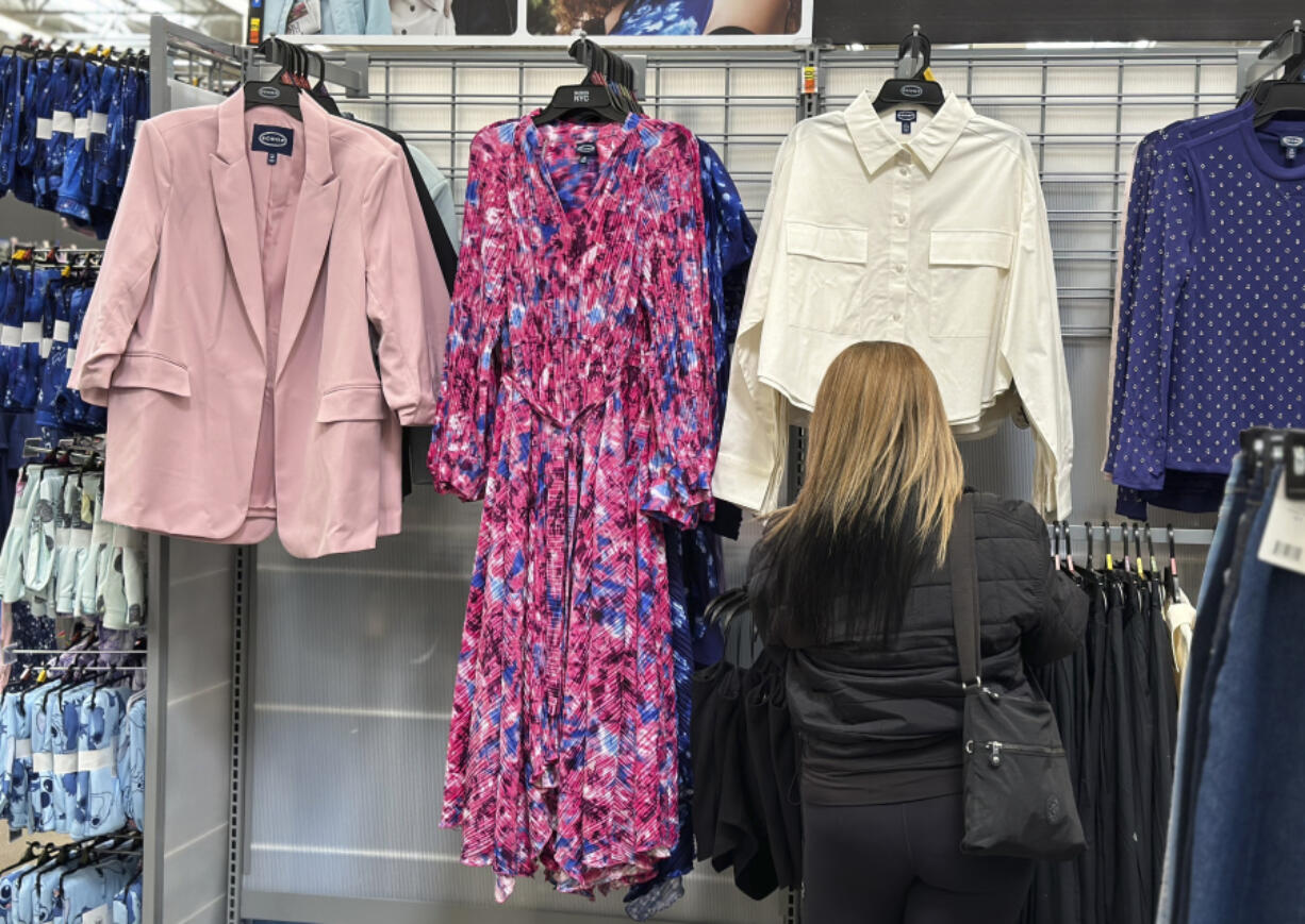 A shopper looks at clothes at a Walmart store in Secaucus, N.J., on March 25, 2024. On Monday, April 15, 2024, the Commerce Department releases U.S.