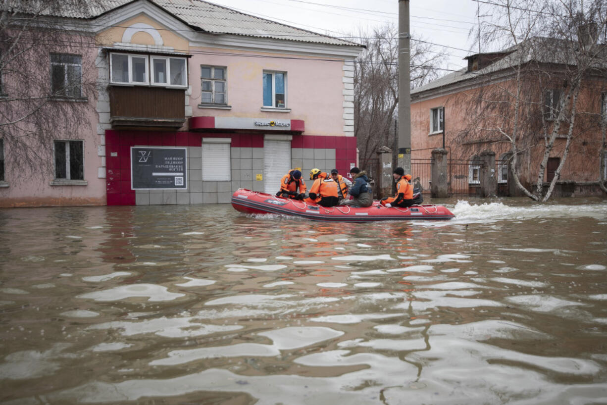 Emergency workers and police ride a boat during evacuations in a flooded street after parts of a dam burst, in Orsk, Russia on Monday, April 8, 2024. Floods caused by rising water levels in the Ural River broke a dam in a city near Russia&#039;s border with Kazakhstan, forcing some 2,000 people to evacuate, local authorities said. The dam broke in the city of Orsk in the Orenburg region, less than 12.4 miles north of the border on Friday night, according to Orsk mayor Vasily Kozupitsa.