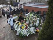 A woman touches a cross at the grave of Russian opposition leader Alexei Navalny on the fortieth day after his death as per Orthodox tradition at the Borisovskoye Cemetery, in Moscow, Russia, Tuesday, March 26, 2024.
