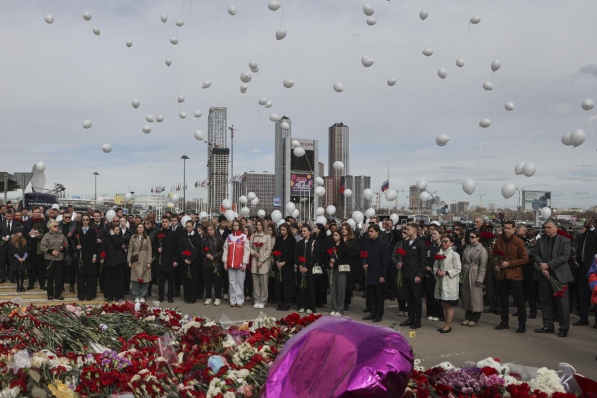 A group of ambassadors of foreign diplomatic missions attend a laying ceremony at a makeshift memorial in front of the Crocus City Hall on the western outskirts of Moscow, Russia, Saturday, March 30, 2024.