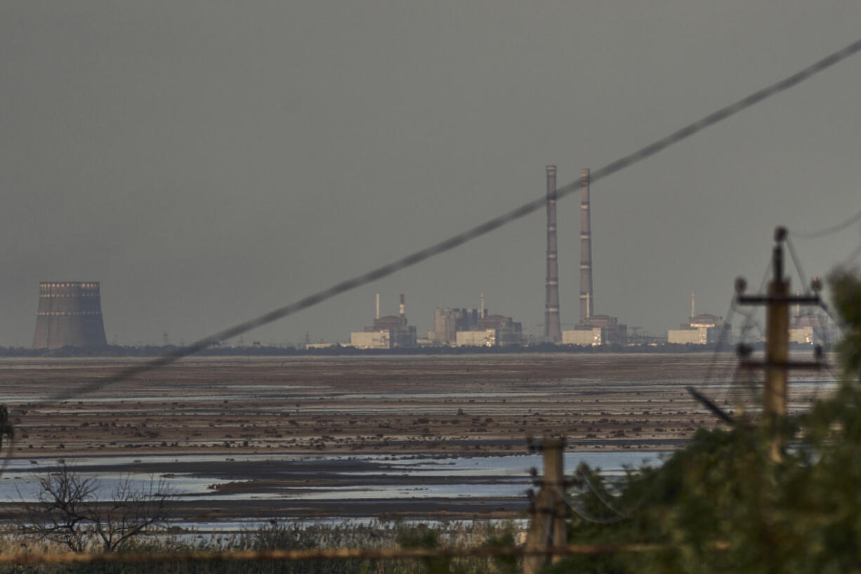 FILE - The Zaporizhzhia nuclear power plant, Europe&rsquo;s largest, is seen in the background of the shallow Kakhovka Reservoir after the dam collapse, in Energodar, Russian-occupied Ukraine, Tuesday, June 27, 2023. Officials at the Russian-controlled Zaporizhzhia Nuclear Power Plant said that the site was attacked Sunday April 7, 2024, by Ukrainian military drones, including a strike on the dome of the plant&rsquo;s sixth power unit.
