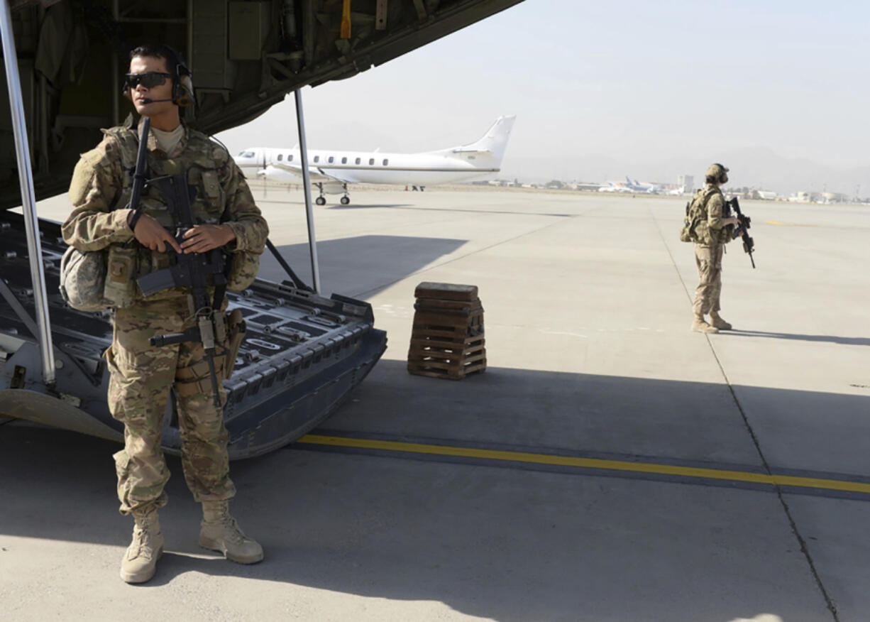 Wilmer Puello-Mota, left, a member of the U.S. Air Force, provides security at Hamid Karzai International Airport in Kabul, Afghanistan, on Aug. 28, 2015. Puello-Mota, a U.S. Air Force veteran and former elected official in Massachusetts who fled the U.S. after being charged with possessing sexually explicit images of a child, told his lawyer he joined Russia&rsquo;s army, and video appears to show him signing documents in a military enlistment office in Siberia, Russia. (Senior Airman Cierra Presentado/U.S.