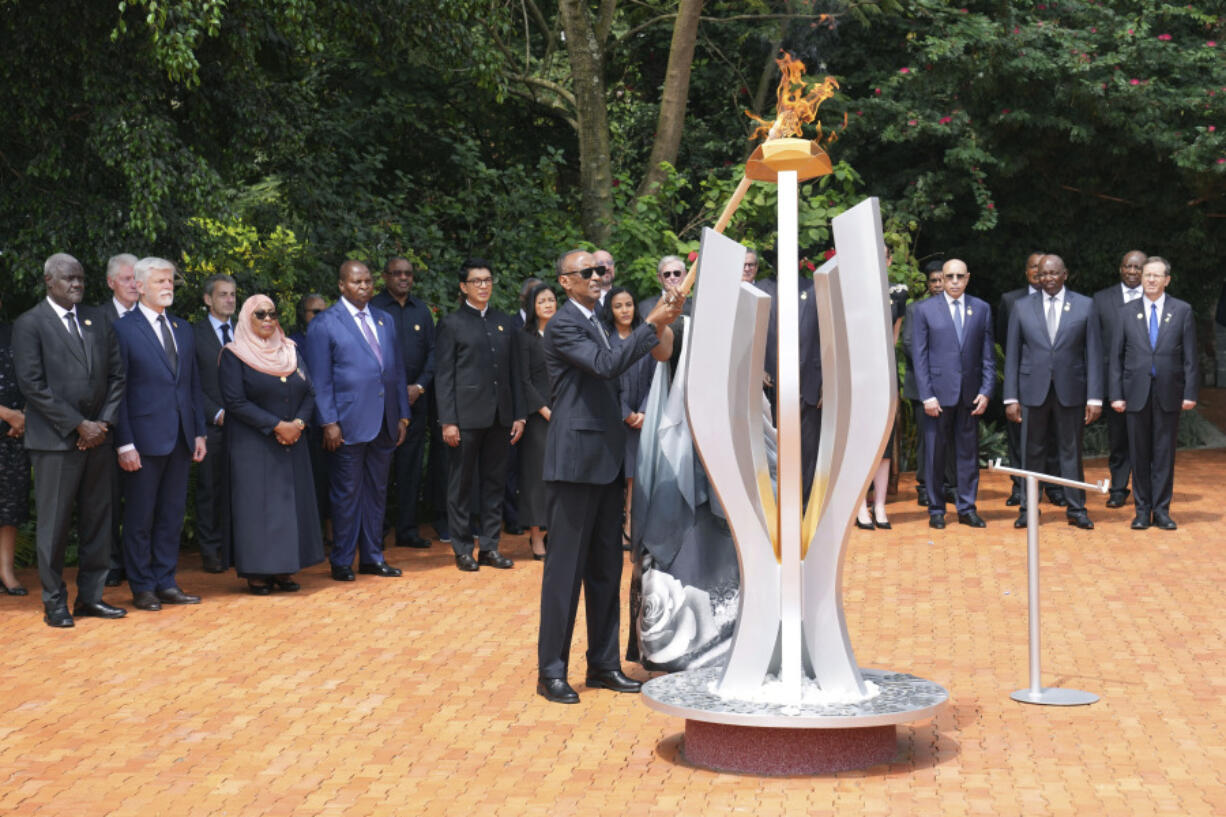 Rwandan President Paul Kagame lights a memorial flame during a ceremony to mark the 30th anniversary of the Rwandan genocide, held at the Kigali Genocide Memorial, in Kigali, Rwanda, Sunday, April 7, 2024. Rwandans are commemorating 30 years since the genocide in which an estimated 800,000 people were killed by government-backed extremists, shattering this small east African country that continues to grapple with the horrific legacy of the massacres.