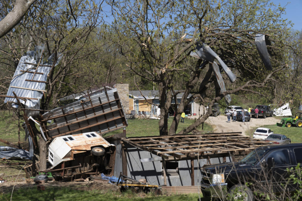 Metal sidings are throw up in trees on Ethan Steenbach&rsquo;s property Tuesday morning in Overbrook, Kan., following a tornado that hit the area. Strong storms have caused damage in parts of the middle U.S. and spawned tornadoes in Kansas and Iowa.