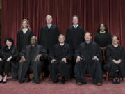 FILE - Members of the Supreme Court sit for a new group portrait following the addition of Associate Justice Ketanji Brown Jackson, at the Supreme Court building in Washington, on Oct. 7, 2022. Bottom row, from left, Associate Justice Sonia Sotomayor, Associate Justice Clarence Thomas, Chief Justice of the United States John Roberts, Associate Justice Samuel Alito, and Associate Justice Elena Kagan. Top row, from left, Associate Justice Amy Coney Barrett, Associate Justice Neil Gorsuch, Associate Justice Brett Kavanaugh, and Associate Justice Ketanji Brown Jackson. The core issue being debated before the Supreme Court on April 25, 2024, boils down to this: Whether a former president is immune from prosecution for actions taken while in office &mdash; and, if so, what is the extent of the immunity? (AP Photo/J.