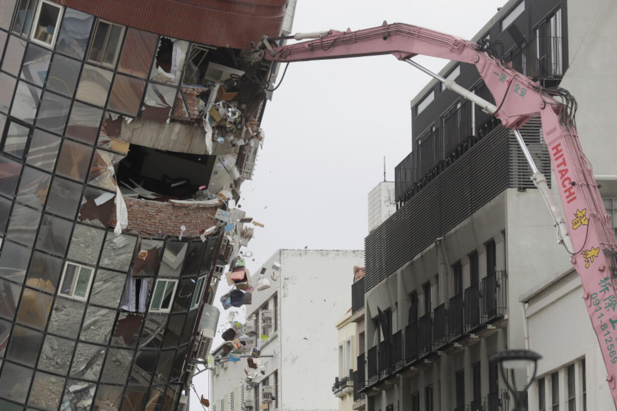 Heavy equipment begins demolition of a collapsed building, two days after a powerful earthquake struck the city, in Hualien City, eastern Taiwan, Friday, April 5, 2024.