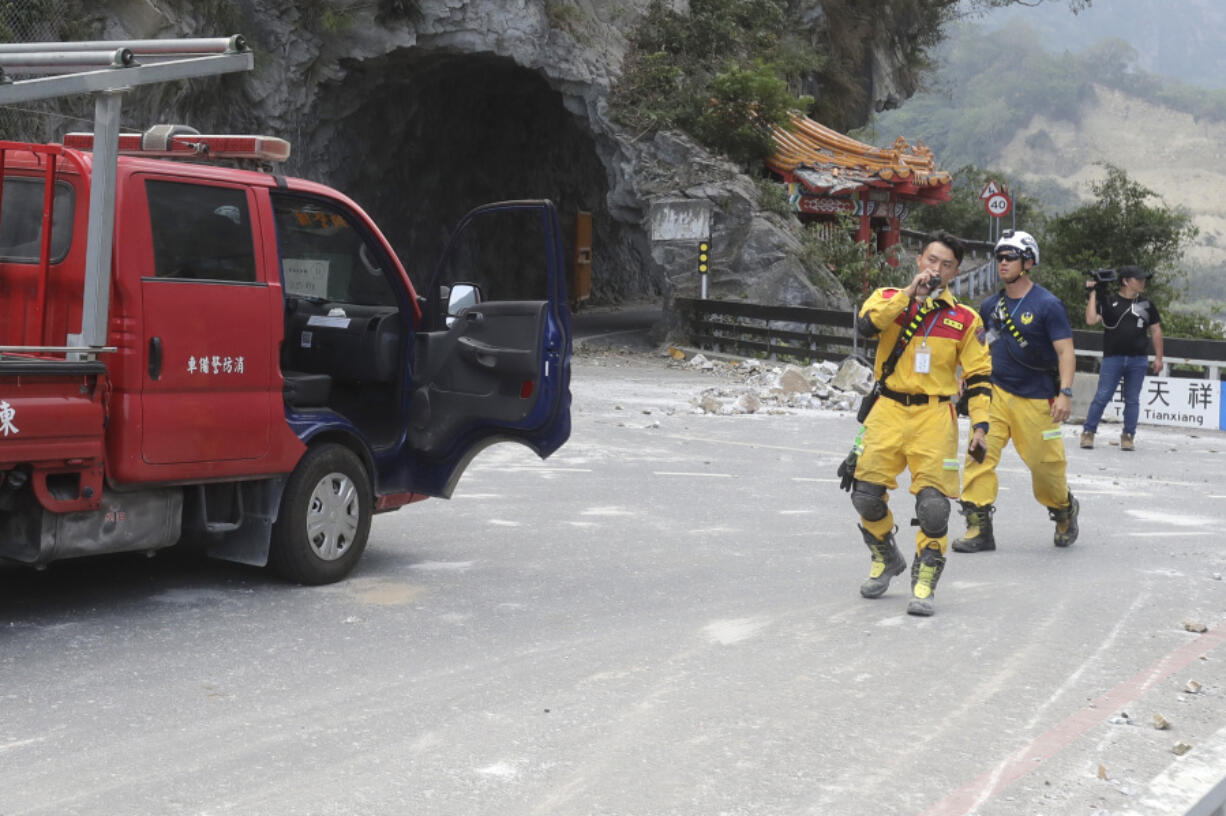 A firefighter regroup at the entrance of Taroko National Park in Hualien County, eastern Taiwan, Thursday, April 4, 2024. The strongest earthquake in a quarter-century has rocked Taiwan during the morning rush hour.