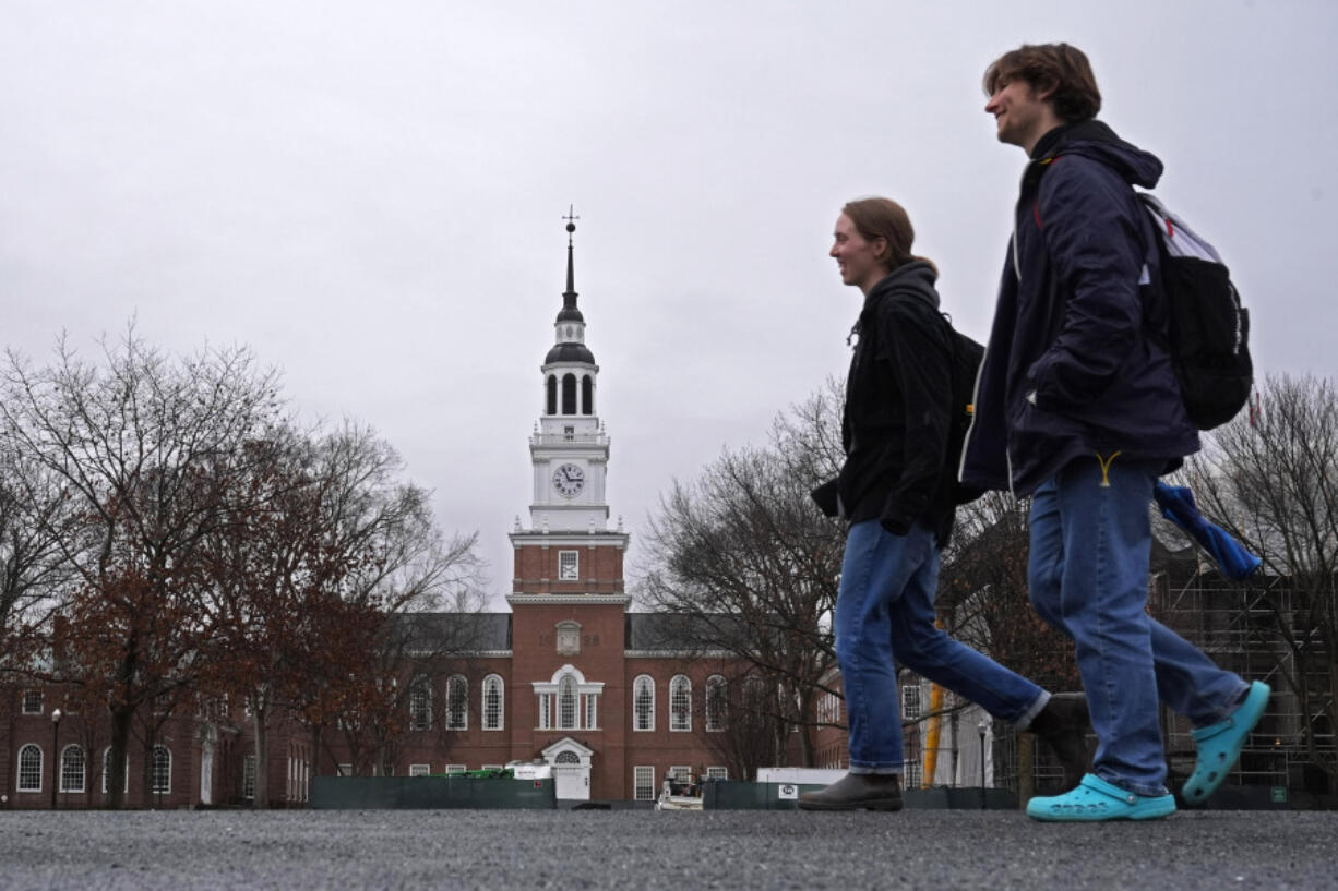 FILE - Students cross the campus of Dartmouth College, March 5, 2024, in Hanover, N.H. While tax pros say it&rsquo;s great for college students to start filing their own forms, parents and students should double-check everything carefully before anyone pushes the &ldquo;submit&rdquo; button. (AP Photo/Robert F.