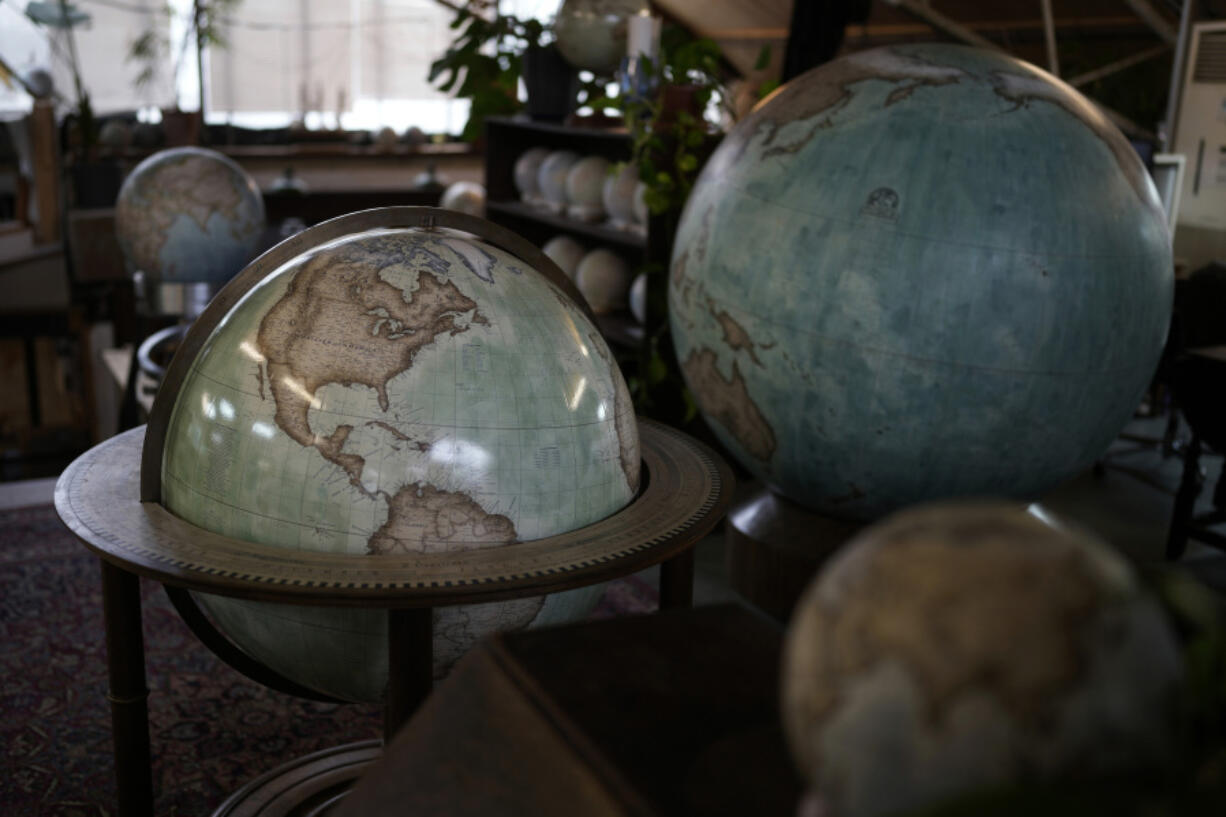 Various size of globes are displayed at the Bellerby &amp; Co. Globemakers studio in London.