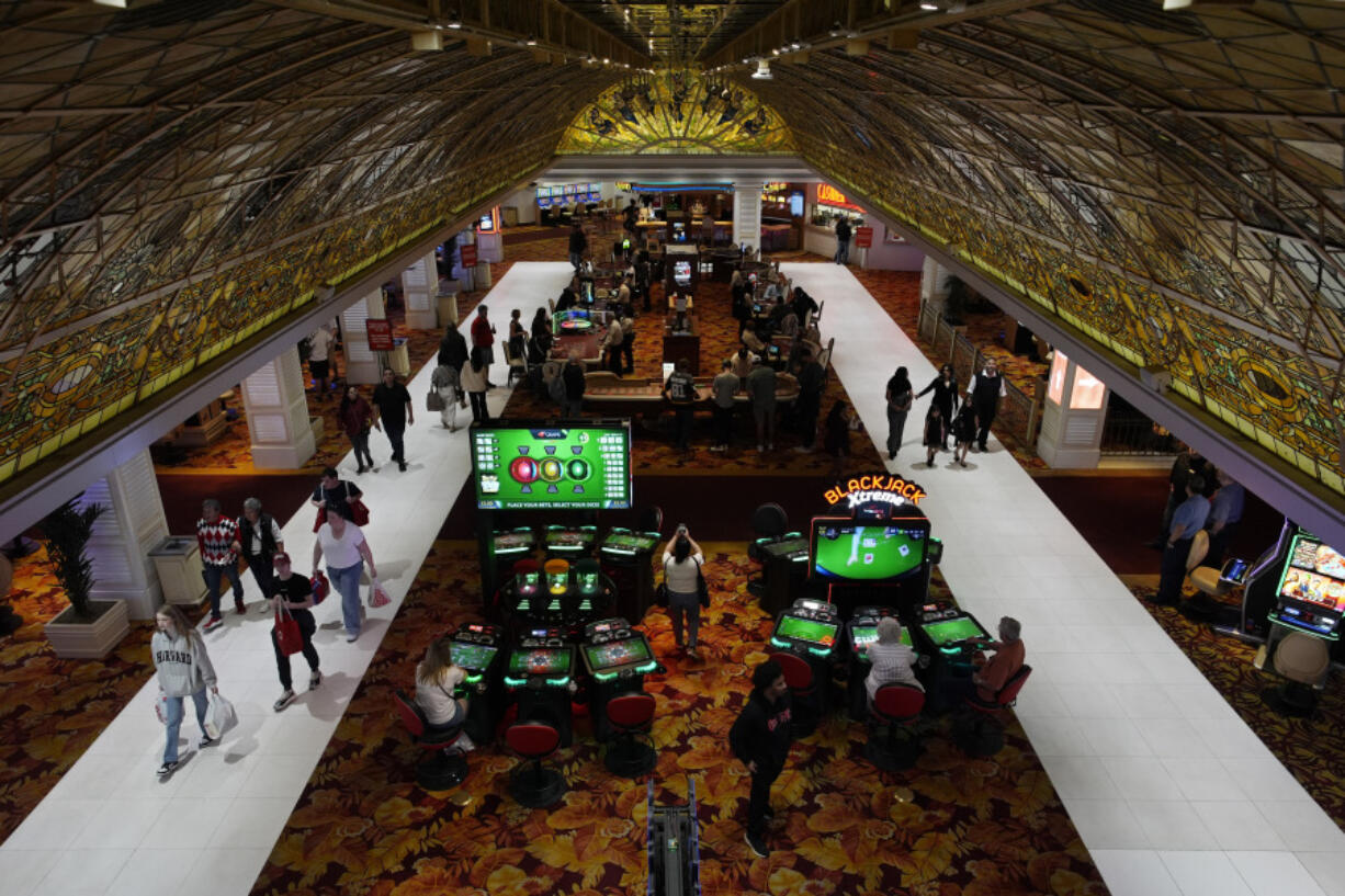 People walk through the casino floor at the Tropicana hotel-casino Friday, March 29, 2024, in Las Vegas. The property is scheduled to close April 2, 2024.