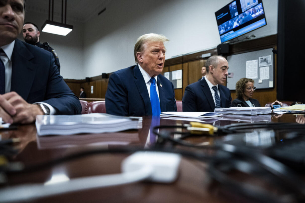 Former President Donald Trump, flanked by attorneys Todd Blanche and Emil Bove, appears at Manhattan criminal court during jury selection in New York, Thursday, April 18, 2024.