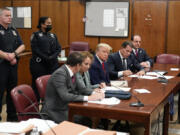 FILE - Former President Donald Trump, center, appears in court for his arraignment, Tuesday, April 4, 2023, in New York. A dozen Manhattan residents are soon to become the first Americans ever to sit in judgment of a former president charged with a crime. Jury selection is set to start Monday in former President Donald Trump&rsquo;s hush-money trial.