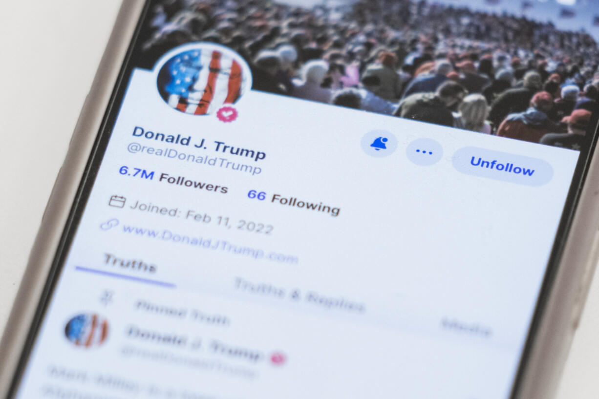 FILE - The Truth Social account for former President Donald Trump is seen on a mobile device, Wednesday, March 20, 2024, in New York. On Monday, April 1, less than a week after a flashy stock market debut, Trump&rsquo;s social media company disclosed that it lost nearly $58.2 million in 2023.