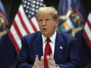 FILE - Republican presidential candidate former President Donald Trump speaks at a campaign event in Grand Rapids, Mich., Tuesday, April 2, 2024. Trump filed a law suit on March 24, suing two co-founders of Trump Media &amp; Technology Group, the newly public owner of his Truth Social platform, arguing that they should forfeit their stock in the company after allegedly setting it up improperly.