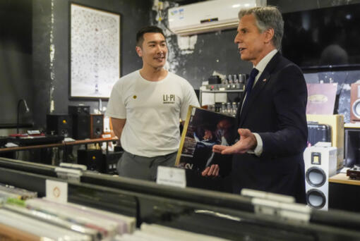 U.S. Secretary of State Antony Blinken talks with Yuxuan Zhou during a visit to Li-Pi record store in Beijing, China, Friday, April 26, 2024.