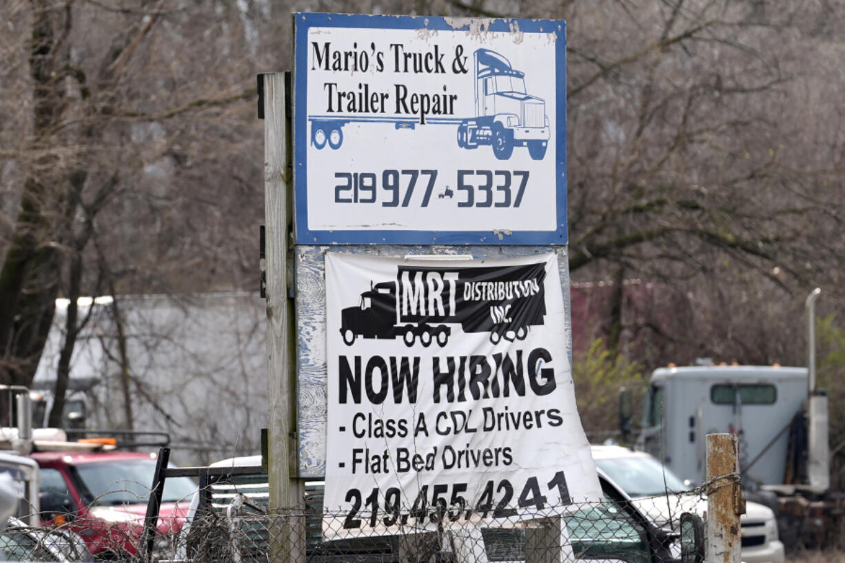 A sign seeking truck drivers is displayed at a business in Gary, Ind., Tuesday, March 26, 2024. On Thursday, April 4, 2024, the Labor Department reports on the number of people who applied for unemployment benefits last week. (AP Photo/Nam Y.