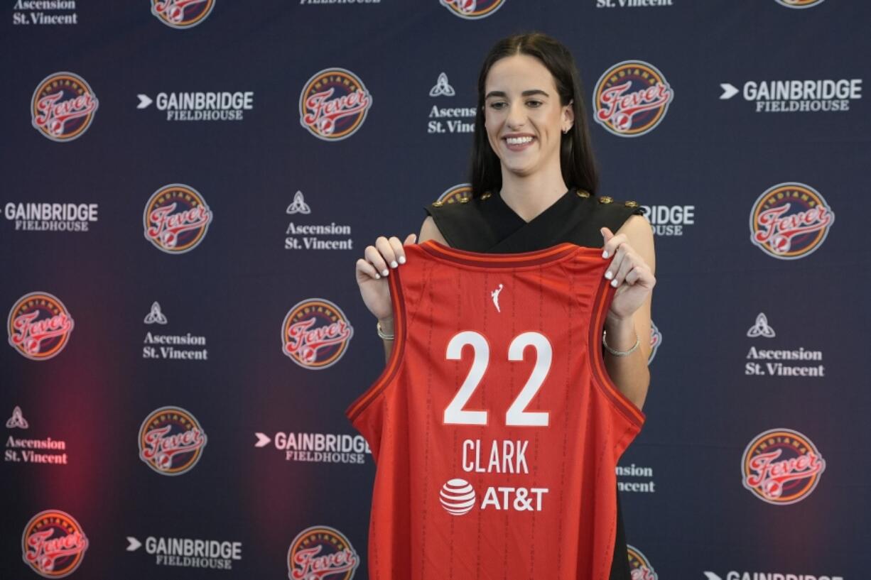 Indiana Fever&rsquo;s Caitlin Clark holds her jersey following a WNBA basketball news conference, Wednesday, April 17, 2024, in Indianapolis.