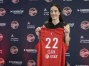 Indiana Fever&rsquo;s Caitlin Clark holds her jersey following a WNBA basketball news conference, Wednesday, April 17, 2024, in Indianapolis.