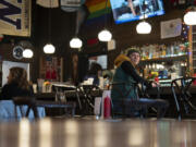A customer looks at sports memorabilia at The Sports Bra sports bar on Wednesday in Portland.