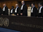 Presiding judge Nawaf Salam, fourth from left, arrives to read the ruling at the International Court of Justice in The Hague, Netherlands, Tuesday, April 30, 2024. The top U.N. court rejected on Tuesday a request by Nicaragua to order Germany to halt military and other aid to Israel and renew funding to the U.N. aid agency in Gaza. The International Court of Justice said that legal conditions for making such an order weren&rsquo;t met and ruled against the request in a 15-1 vote.