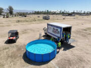 Crews drain a reusable swimming pool left after the Stagecoach Festival that concluded Sunday at the Empire Polo Fields in Indio. Items left behind after the festivals are often donated to charitable organizations. (Allen J.