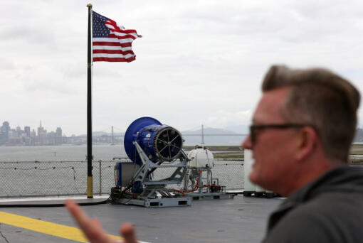 Dr. Rob Wood on the flight deck of the USS Hornet Museum with a Cloud Aerosol Research Instrument on Wednesday, April 24, 2024, in Alameda, California.
