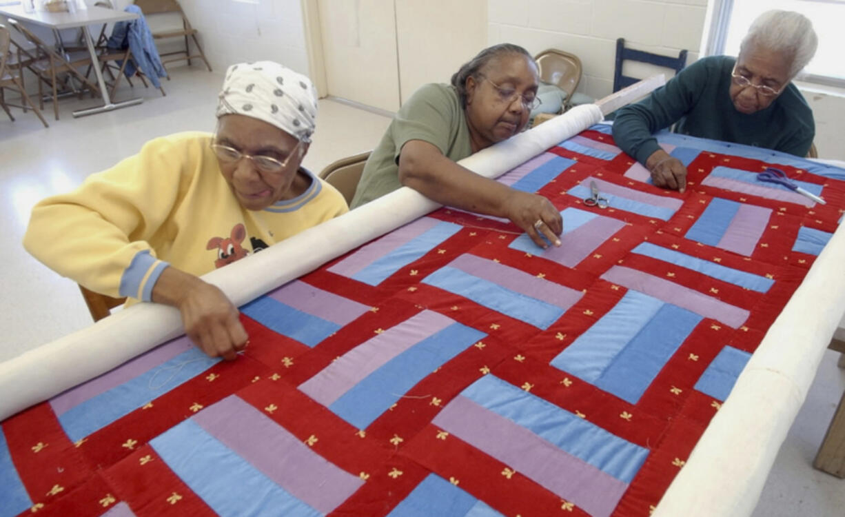 Gee&rsquo;s Bend Quilters, from left, Lucy Marie Mingo, Nancy Pettway and Arlonzia Pettway work on a quilt April 6, 2006, in the Boykin nutrition center in Boykin, Ala. Target launched a limited-edition collection based on the Gee&rsquo;s Bend quilters&rsquo; designs for Black History Month in 2024. The Target designs were &ldquo;inspired by&rdquo; five Gee&rsquo;s Bend quilters who reaped limited financial benefits from the collection&rsquo;s success.