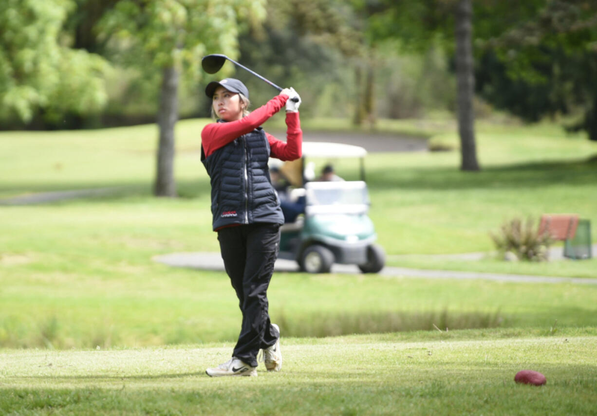 Camas's Jacinda Lee watches her tee shot on the 15th hole during the Class 4A District 4 girls golf tournament on Tuesday at Lewis River Golf Course. Lee won for the third year in a row, this time by 16 strokes.