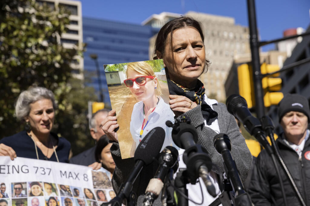 Catherine Berthet holds a photo of her daughter, Camille Geoffroy, after she and other relatives of those killed in two Boeing 737 Max crashes spoke at a federal court arraignment in Fort Worth, Texas, in January 2023.