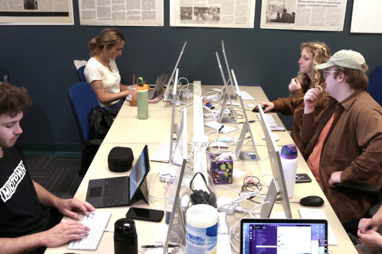 DePaul student journalists, Ryan Hinske, front left, and Nadine DeCero, front right, Jake Cox and Zoe Hanna, work on stories in the newsroom at DePaul University in Chicago, on May 17, 2024. DePaul journalists covered the protests and encampments at the school.