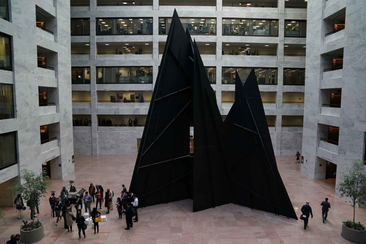 Members of the National Iranian American Council gather at the base of the &ldquo;Mountains and Clouds&rdquo; sculpture in the Hart Senate Office Building before delivering a petition to members of Congress on Capitol Hill Oct. 18, 2017, in Washington, D.C. With more than 43,000 signatures, the petition calls on Congress to pass legislation to rescind the latest version of the Trump Administration&rsquo;s travel ban.