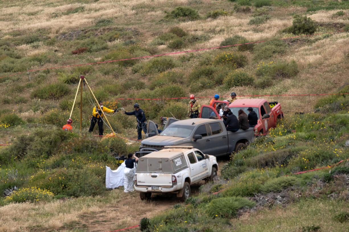 Rescue workers, forensics, and prosecutors work in a waterhole where human remains were found near La Bocana Beach, Santo Tomas delegation, in Ensenada, Mexico, on May 3, 2024.