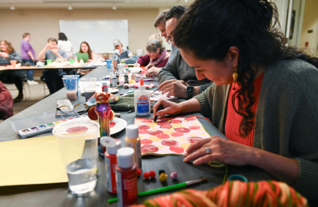 Arezoo Rabbaninn draws circles on her art project at the Camas Public Library&rsquo;s Feb. 17 Bad Art Night. The next Bad Art Night is May 18.