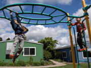 First-graders Arashi Buell, left, and Temour Pashigorev enjoy playtime at Gardner School of Arts &amp; Sciences in Mount Vista during recess on Monday afternoon. Gardner is a local nonprofit school based in experiential learning. School leaders announced Wednesday they are acquiring Country Friends Child Care Center in Hockinson, which will double their total enrollment.