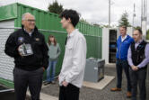 Gov. Jay Inslee, from left, talks with junior and environmental club president Isaac Segal, 17, as he stops by with Department of Ecology staff to hear about air quality monitoring being conducted at a station at Mountain View High School on Wednesday morning. The site is owned and operated by the Department of Ecology in partnership with the school and the Southwest Clean Air Agency.