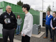 Gov. Jay Inslee, from left, talks with junior and environmental club president Isaac Segal, 17, as he stops by with Department of Ecology staff to hear about air quality monitoring being conducted at a station at Mountain View High School on Wednesday morning. The site is owned and operated by the Department of Ecology in partnership with the school and the Southwest Clean Air Agency.
