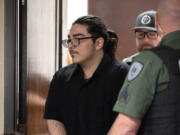 Julio Segura makes his way into the courtroom Monday for his murder trial in the 2022 death of off-duty Vancouver police Officer Donald Sahota at the Clark County Courthouse.