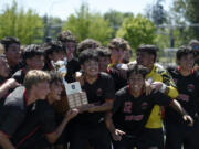 Columbia-White Salmon players pose with the championship trophy after the Class 1A boys soccer District 4 championship match on Saturday, May 11, 2024 at Seton Catholic High School.