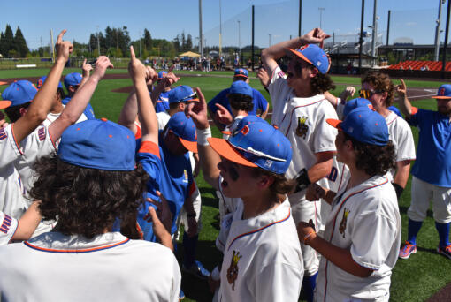 Members of the Ridgefield baseball team celebrate their 6-0 win over Mark Morris in a 2A district winner-to-state baseball game at the Ridgefield Outdoor Recreation Center on Saturday, May 11, 2024.