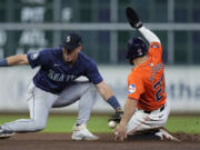 Seattle Mariners shortstop Dylan Moore misses the tag as Houston Astros' Jose Altuve steals second base during the seventh inning of a baseball game Friday, May 3, 2024, in Houston. The play was Altuve's 300th career steal. (AP Photo/Kevin M.