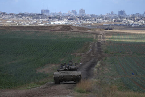 An Israeli Defense Forces tank drives away from the Gaza Strip, as seen from southern Israel, Monday, May 6, 2024.